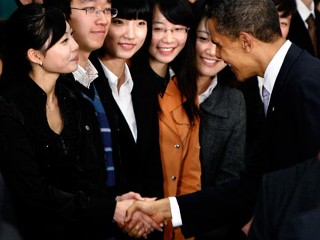 PHOTO U.S. President Barack Obama shakes hands with student Wang Zifei,